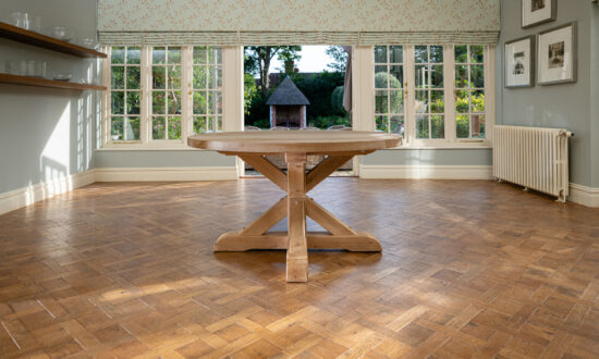 Oxenwood's wooden aubrey circular dining table shown in a parquet floored dining room