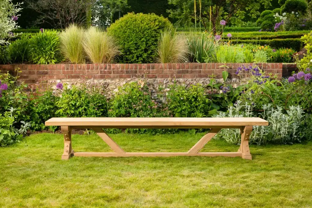 Wooden outdoor bench on grassy garden lawn