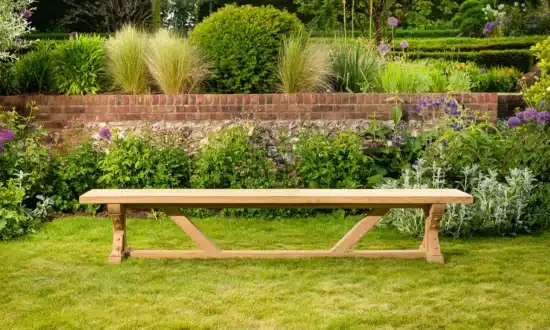 Wooden outdoor bench on grassy garden lawn