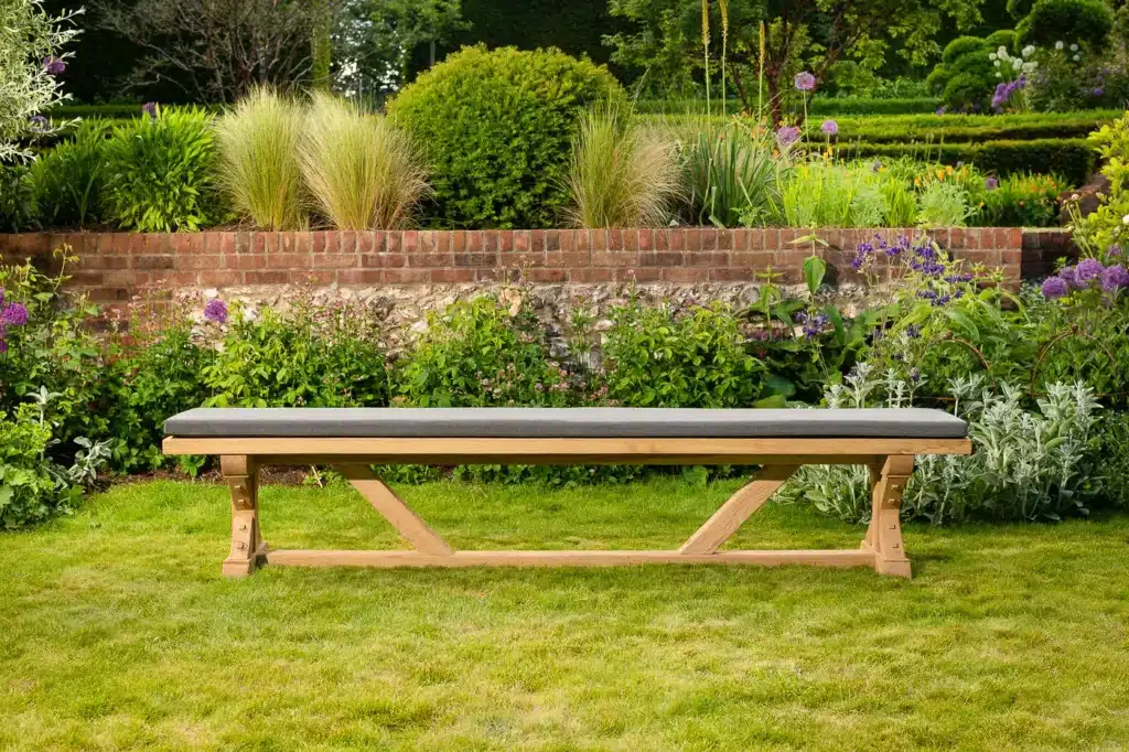 Wooden outdoor bench on grassy garden lawn