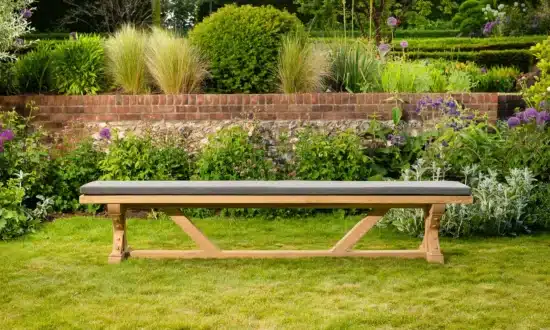 Wooden outdoor bench on grassy garden lawn