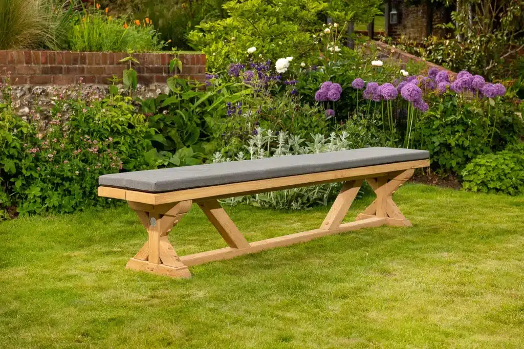 Wooden outdoor bench on grassy garden lawn
