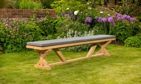 Wooden outdoor bench on grassy garden lawn