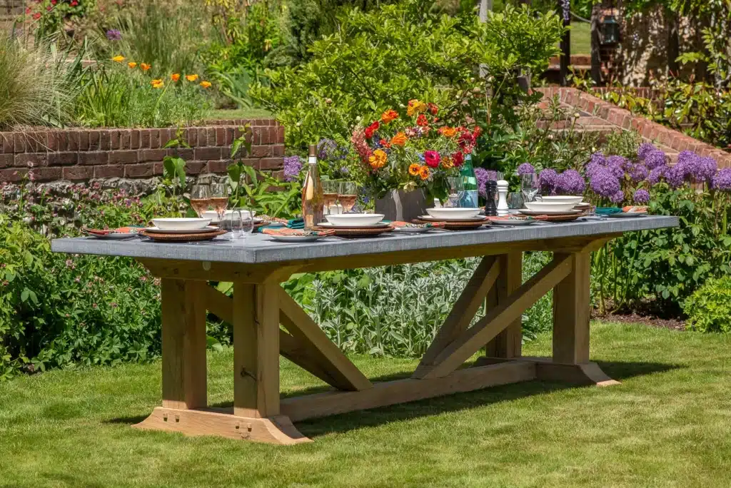 Hagen premium outdoor dining table fully set with plates and flowers