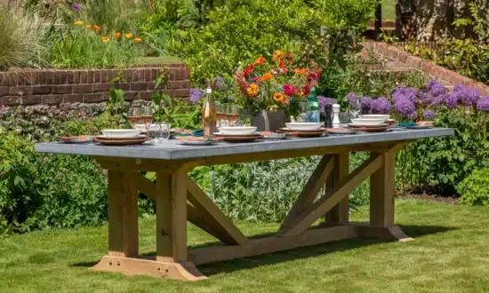 Hagen premium outdoor dining table fully set with plates and flowers