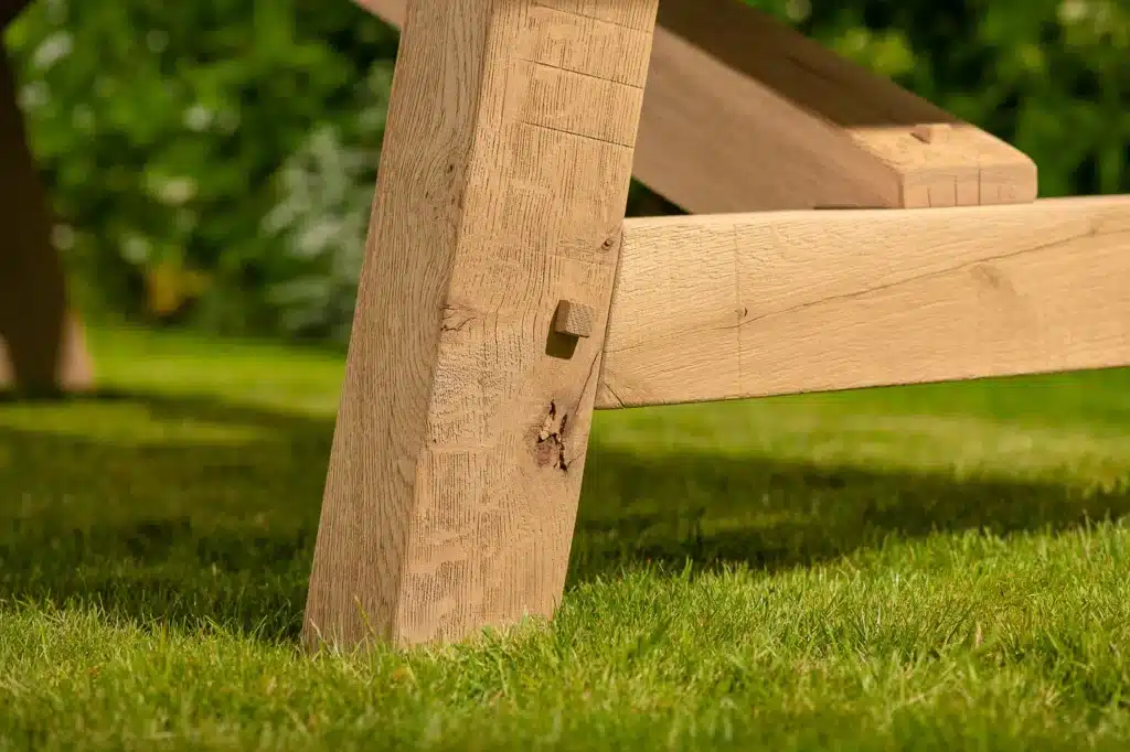 Lucius outdoor dining table - close up of solid oak leg joint