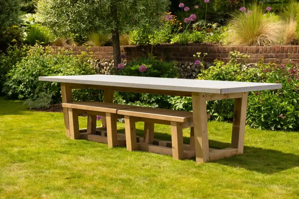 Marcus luxury outdoor dining table with benches in a garden setting