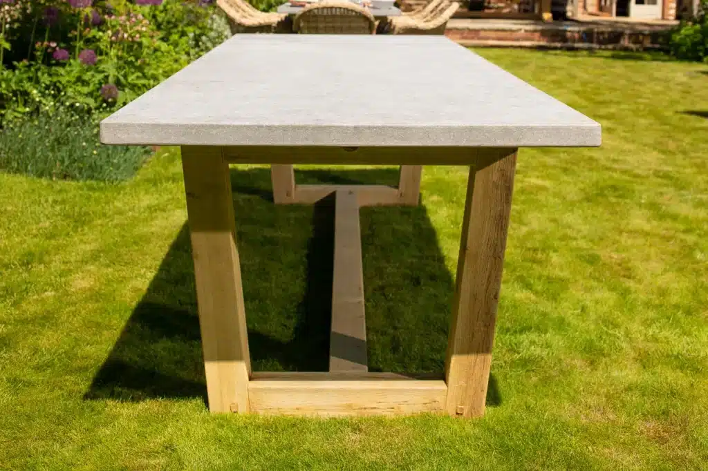 Bluestone topped outdoor dining table in a grassy garden