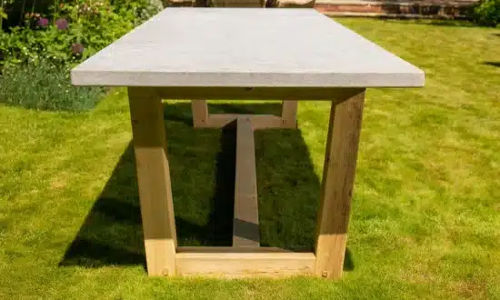 Bluestone topped outdoor dining table in a grassy garden
