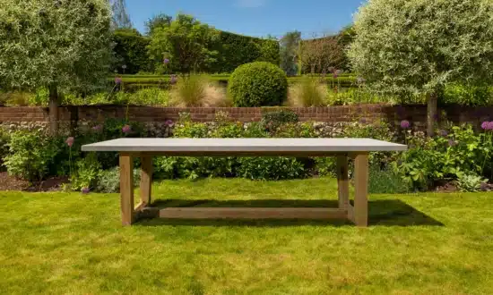Bluestone topped outdoor dining table in a grassy garden