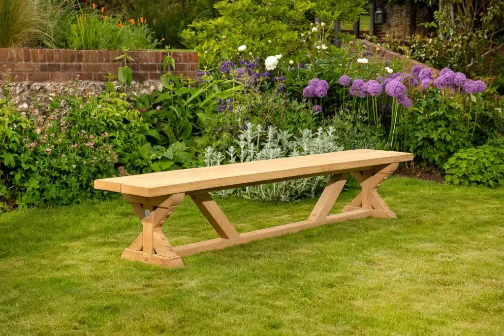 Wooden outdoor bench on grassy garden lawn