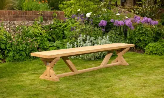 Wooden outdoor bench on grassy garden lawn