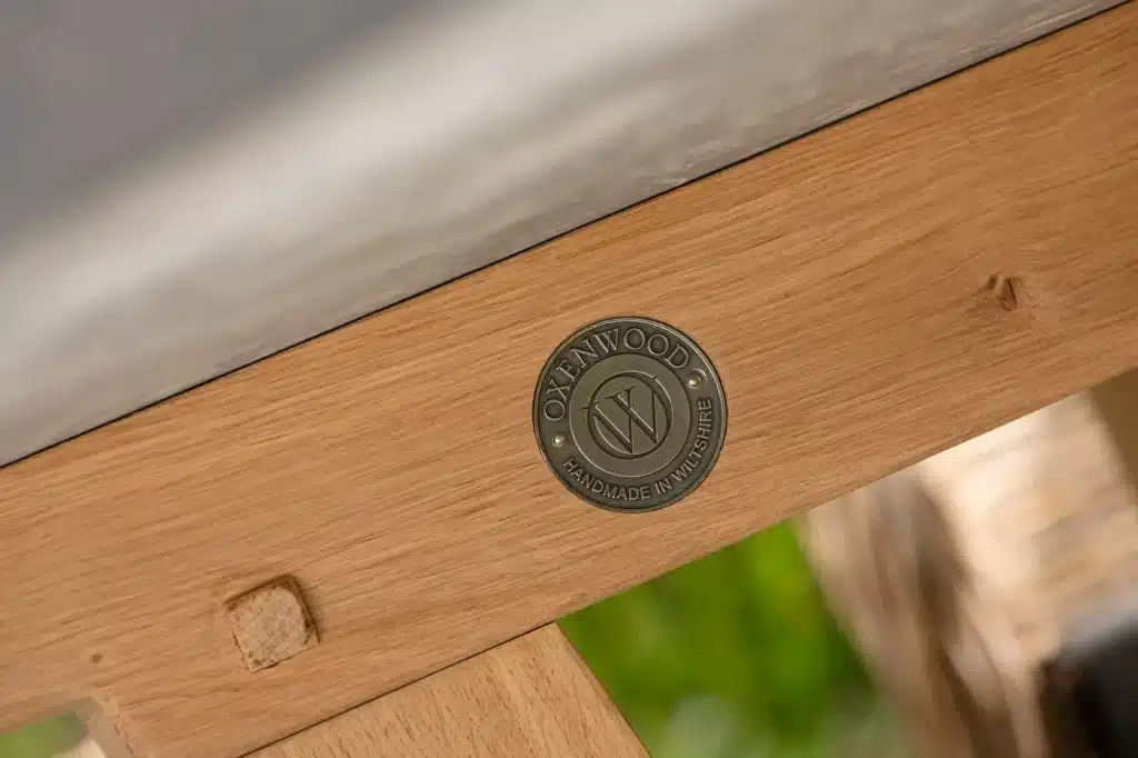 Close up of Quintus luxury circular table zoomed in on embossed Oxenwood brand seal