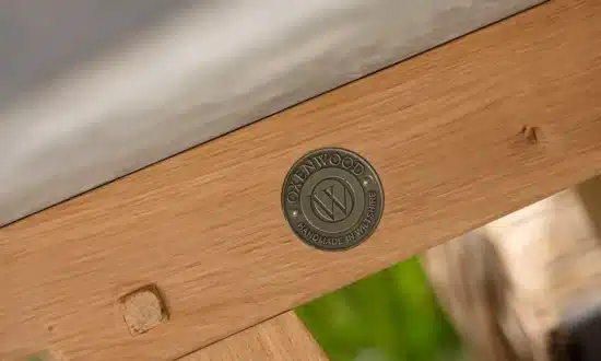 Close up of Quintus luxury circular table zoomed in on embossed Oxenwood brand seal
